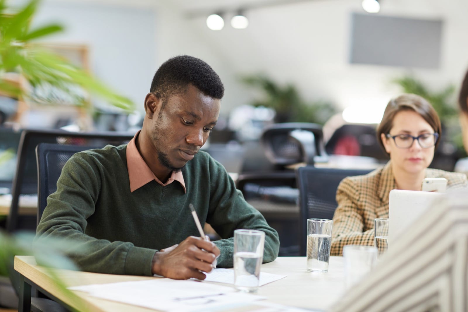 Two people writing a Psychometric Assessment